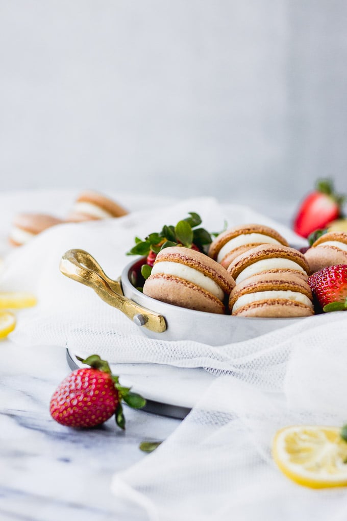 strawberry macarons in silver pot on marble board
