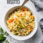 carrot leek risotto in bowls with blue linen by fork in the kitchen
