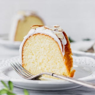 slice of lemon almond cake on plate with fork