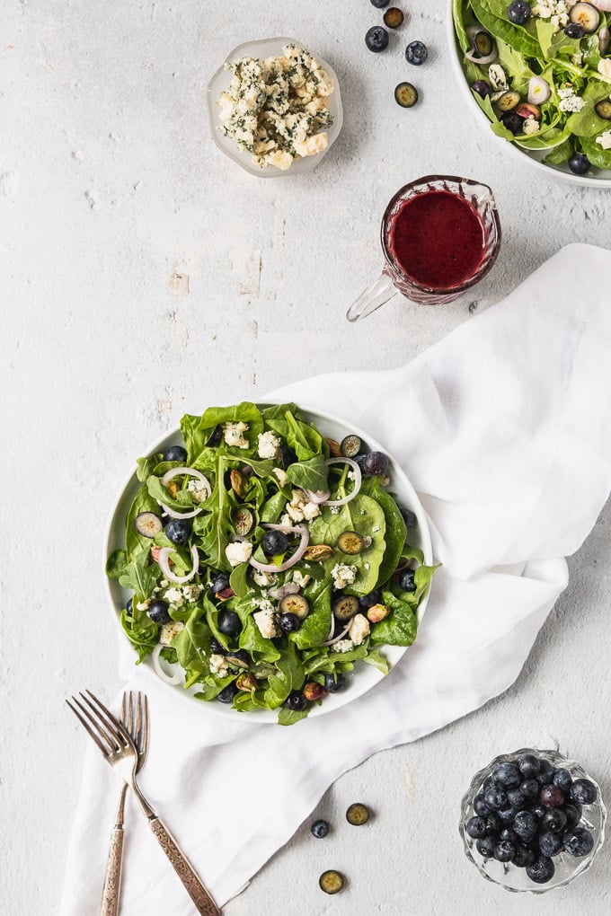 blueberry spinach salad in white bowl