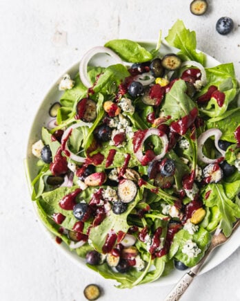 blueberry spinach salad in white bowl