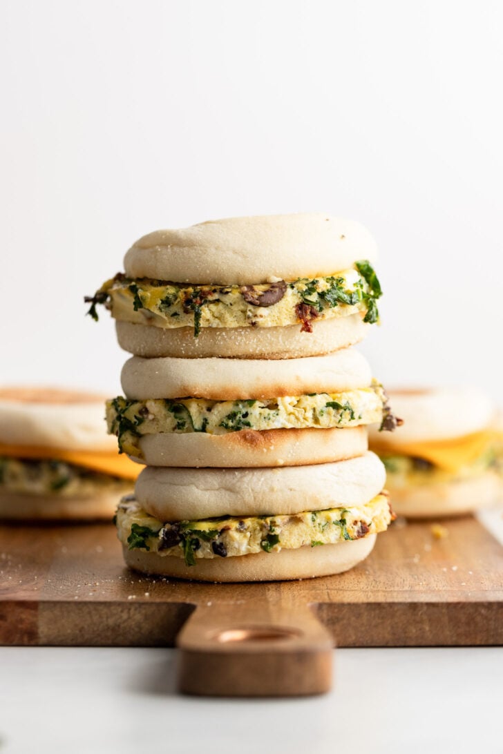 Stack of 3 vegetarian breakfast sandwiches with Mediterranean filling.