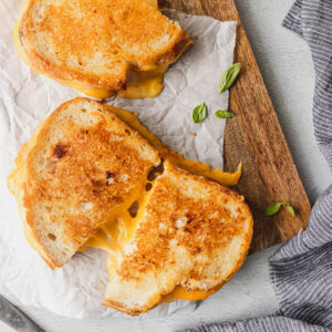 overhead shot of grilled cheese cut with a cheese pull