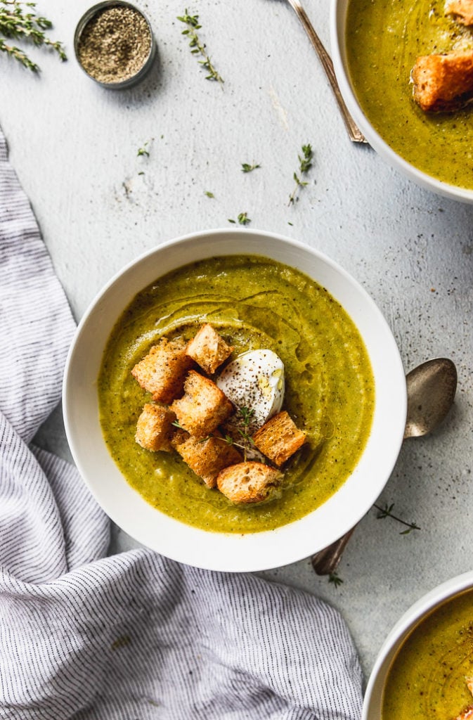 bowl of broccoli squash soup with olive oil drizzle