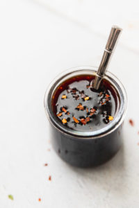 Spicy Teriyaki Sauce in jar with spoon.