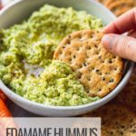 cracker dipping in edamame hummus