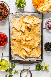 photos repeating adding cheese and toppings to nachos in quick repeating fashion