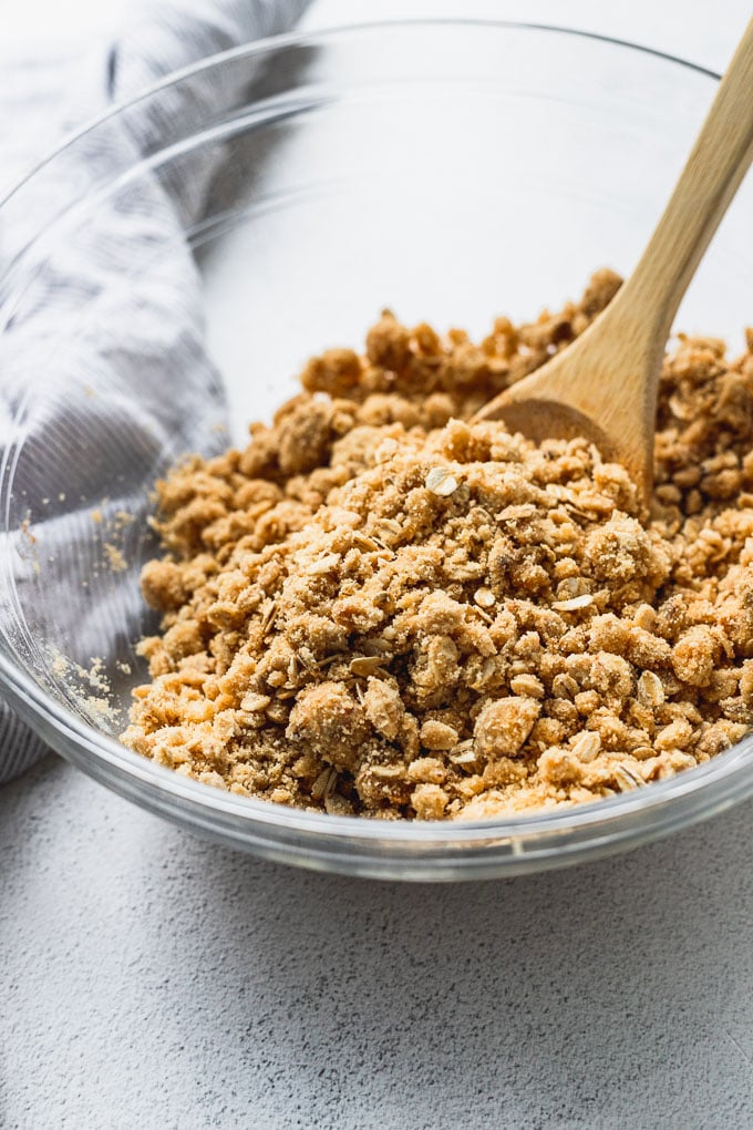 up close look of crust and crumble with wooden spoon