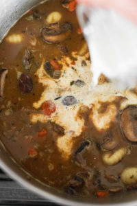 Half and half into mushroom gnocchi soup.