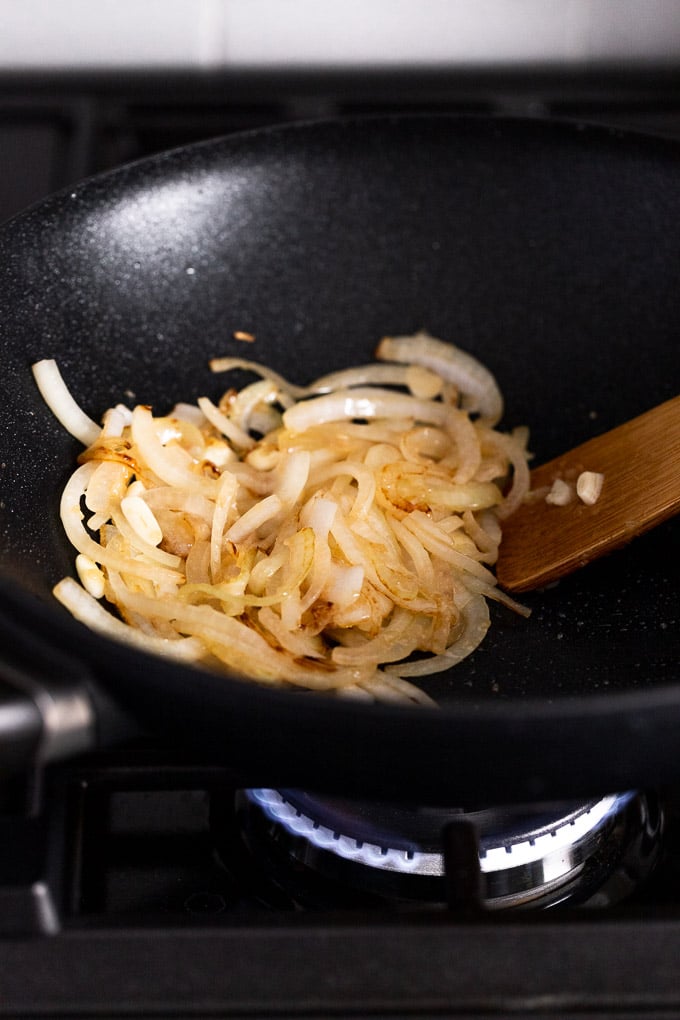 Golden onions in wok.