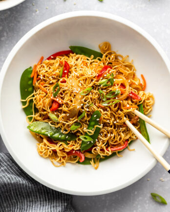 white bowl with vegetable lo mein and chopsticks