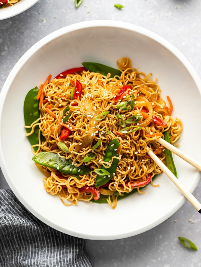 white bowl with vegetable lo mein and chopsticks