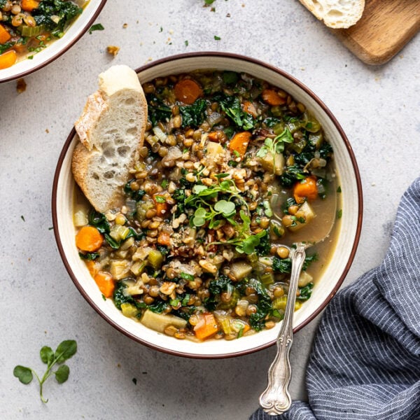 bread in bowl of vegetable lentil soup