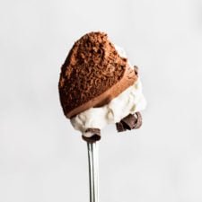 spoon with chocolate mousse and whipped cream