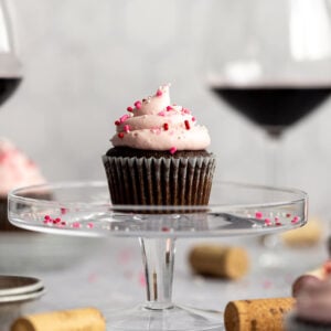 red wine cupcake on cake stand with wine glasses