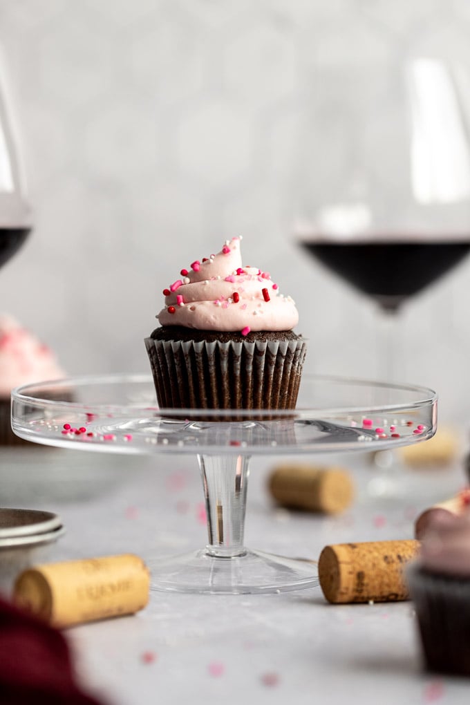 red wine cupcake on cake stand with wine glasses