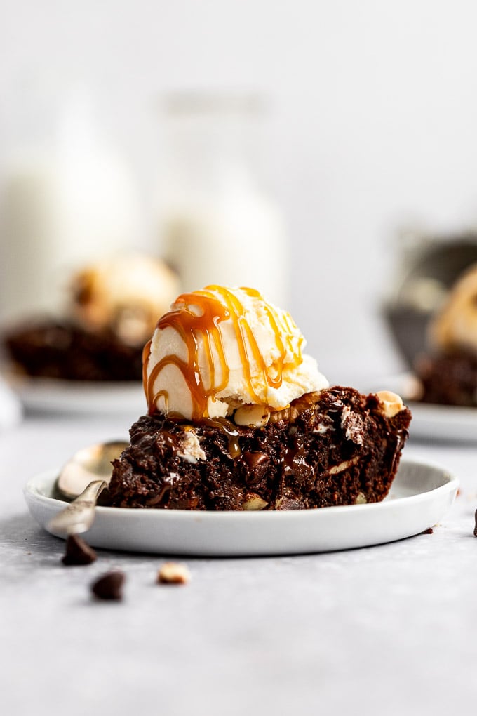 slice of triple chocolate skillet cookie with ice cream and caramel