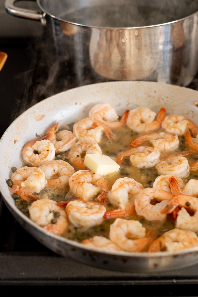 Skillet with shrimp added and butter.