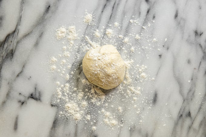 Dough ball lightly sprinkled with flour.