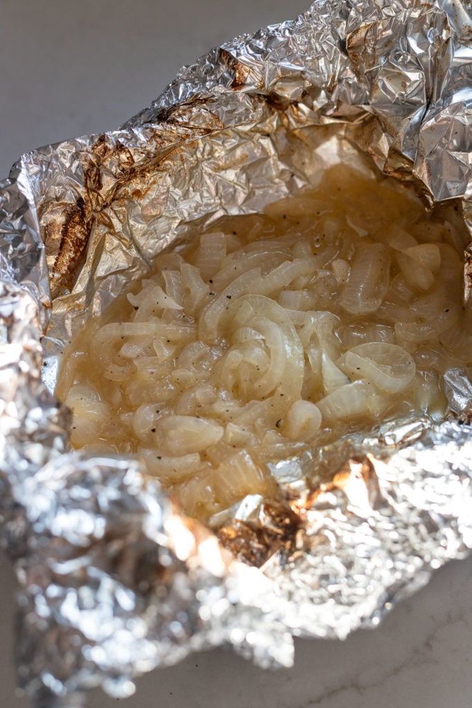 Opened foil packet after grilling with caramelized onions.