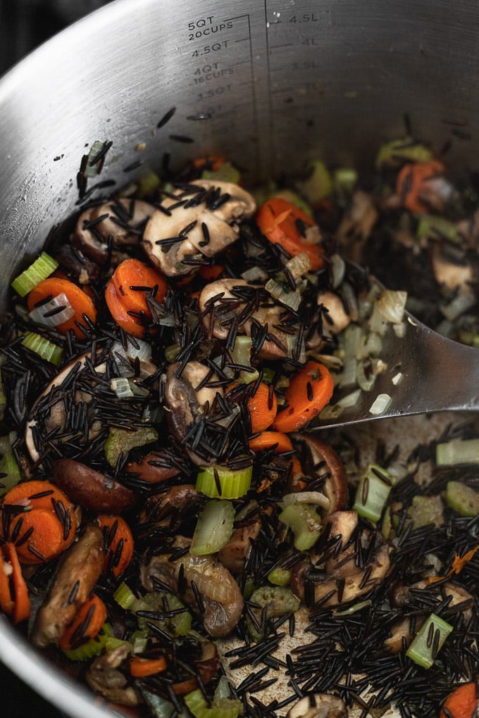 Wild rice added to pot with vegetables.