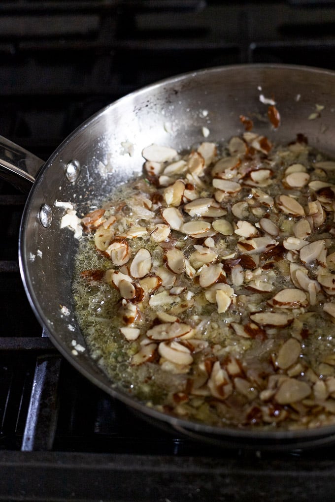 Shallot, garlic, and almonds in skillet.