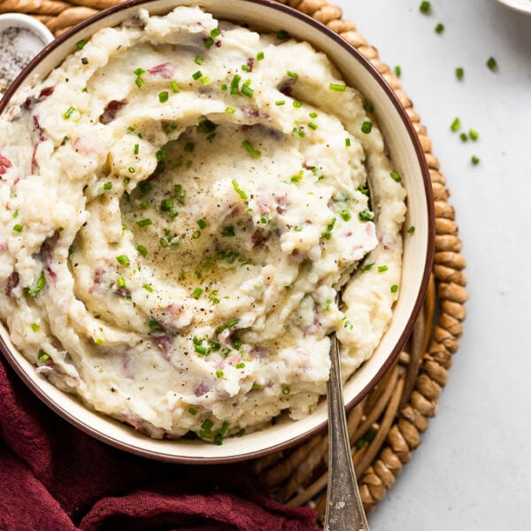 Mashed potatoes in bowl with spoon.
