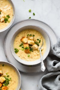 Potato soup in bowl with spoon.