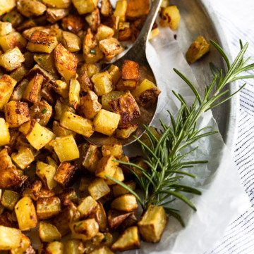 Tray of diced potatoes with rosemary.