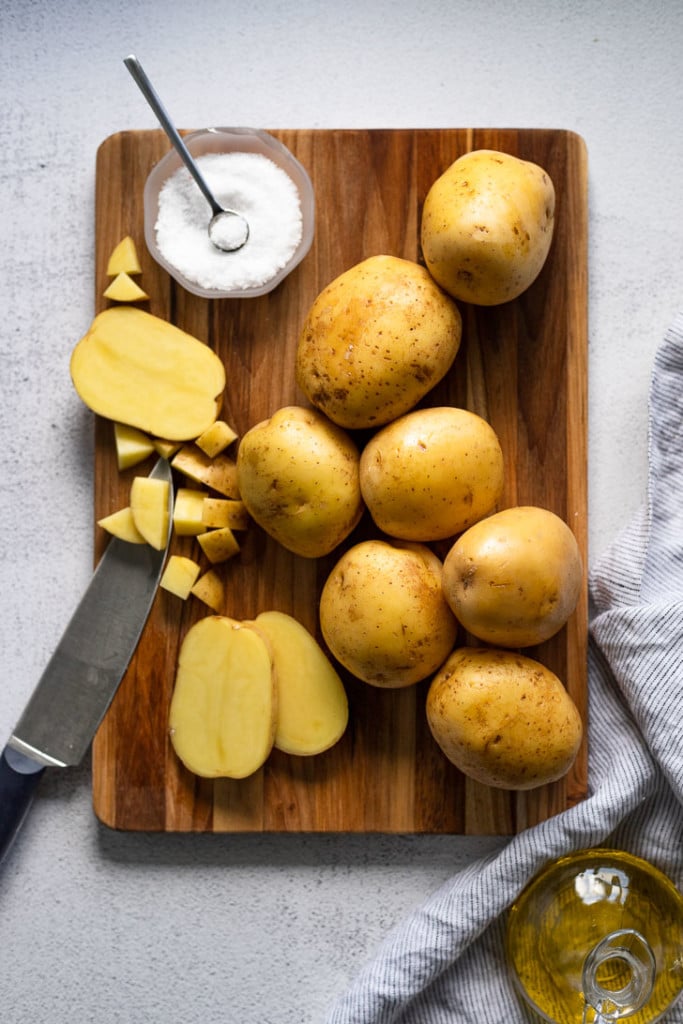 Potatoes on cutting board.