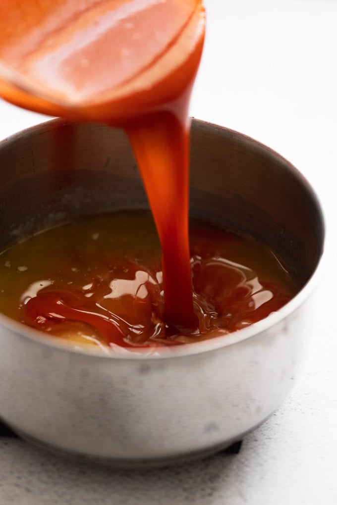 Hot sauce pouring into saucepan.
