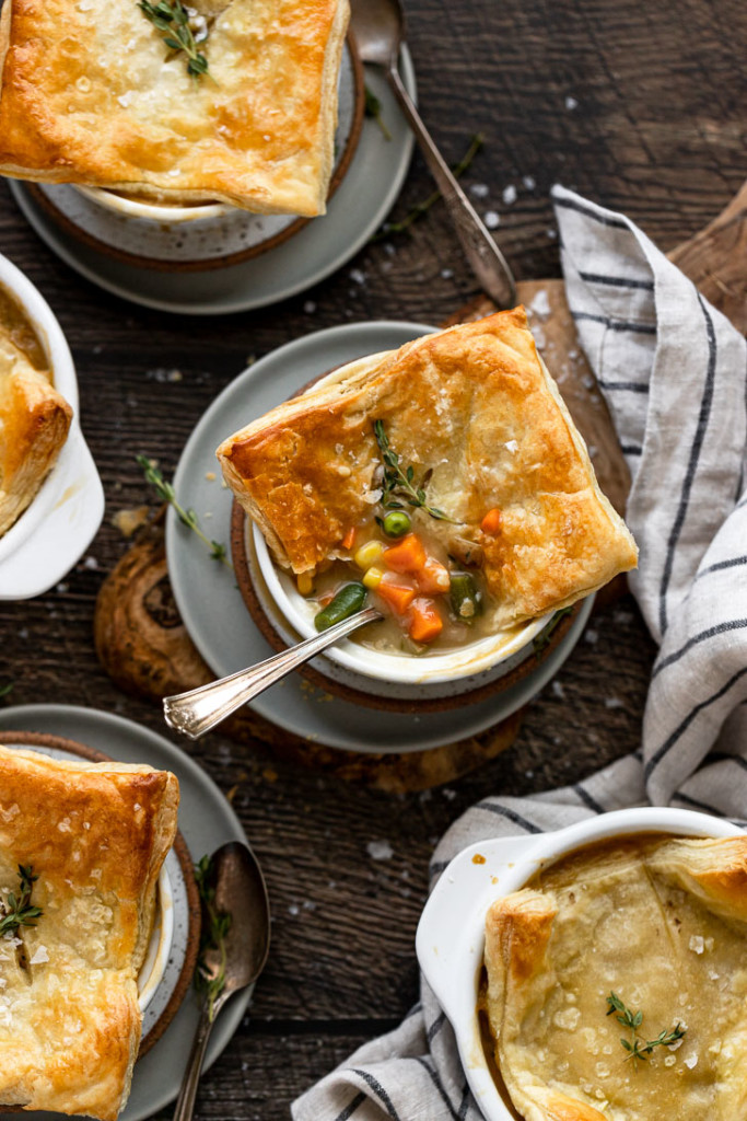 Overhead of pot pies with spoon inside.