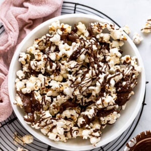 Bowl of chocolate drizzled popcorn.