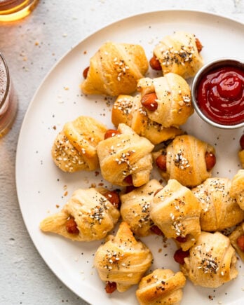 Pigs in a blanket on a plate.