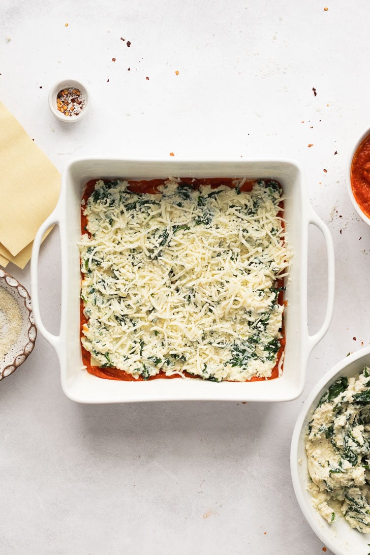 Ricotta spinach filling spread out with mozzarella cheese on top.