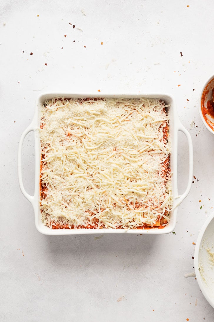 Shredded mozzarella on top of lasagna before baking.