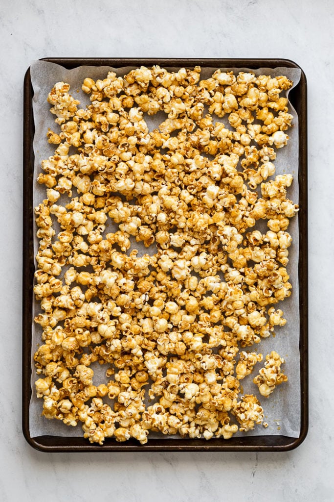 Sheet pan with caramel popcorn.