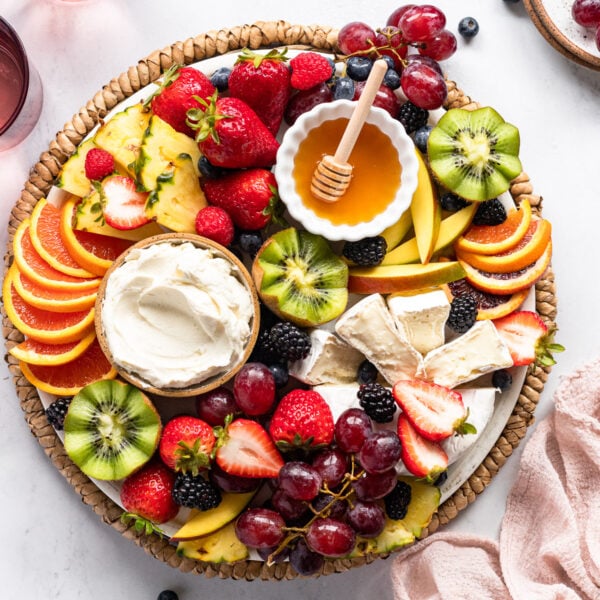 Fruit board with fruit dip, honey, and cheese.