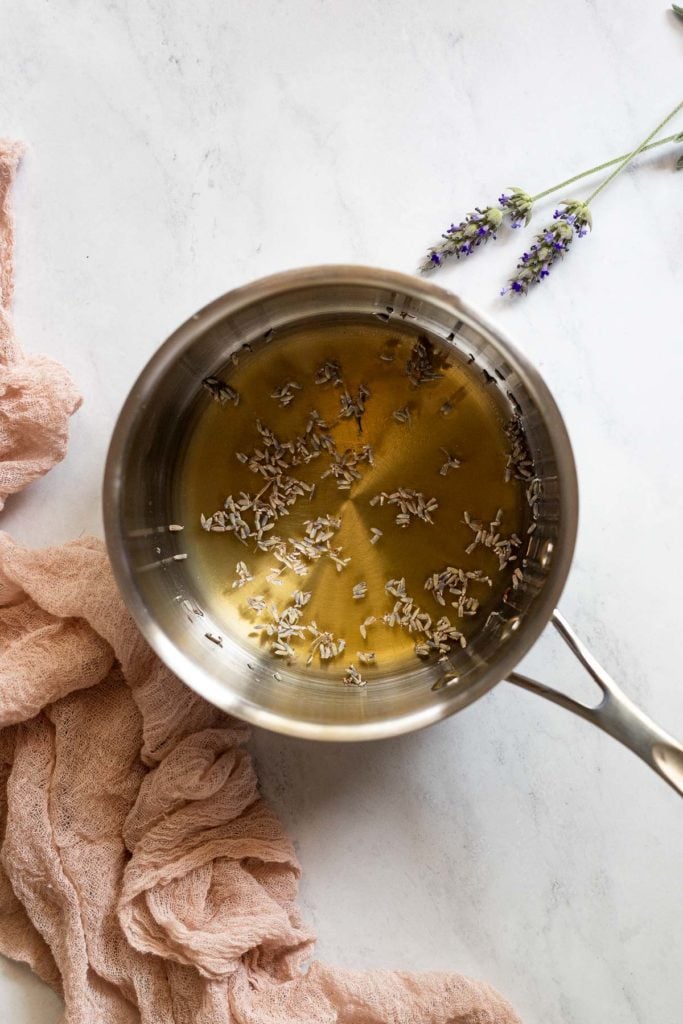 Saucepan with honey and lavender flowers.