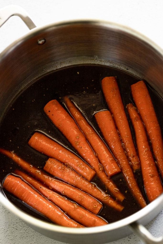 Pot with marinade and carrots.