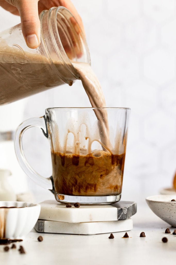 Chocolate milk pouring into espresso.