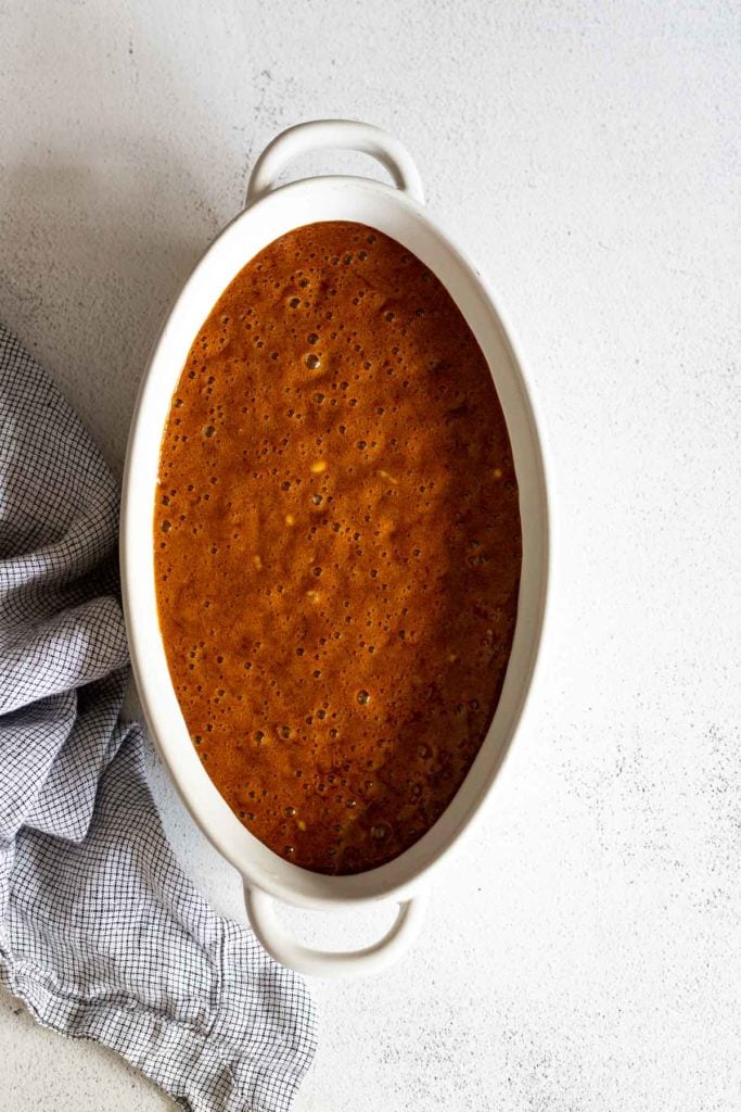 BAked beans spread in a baking dish.