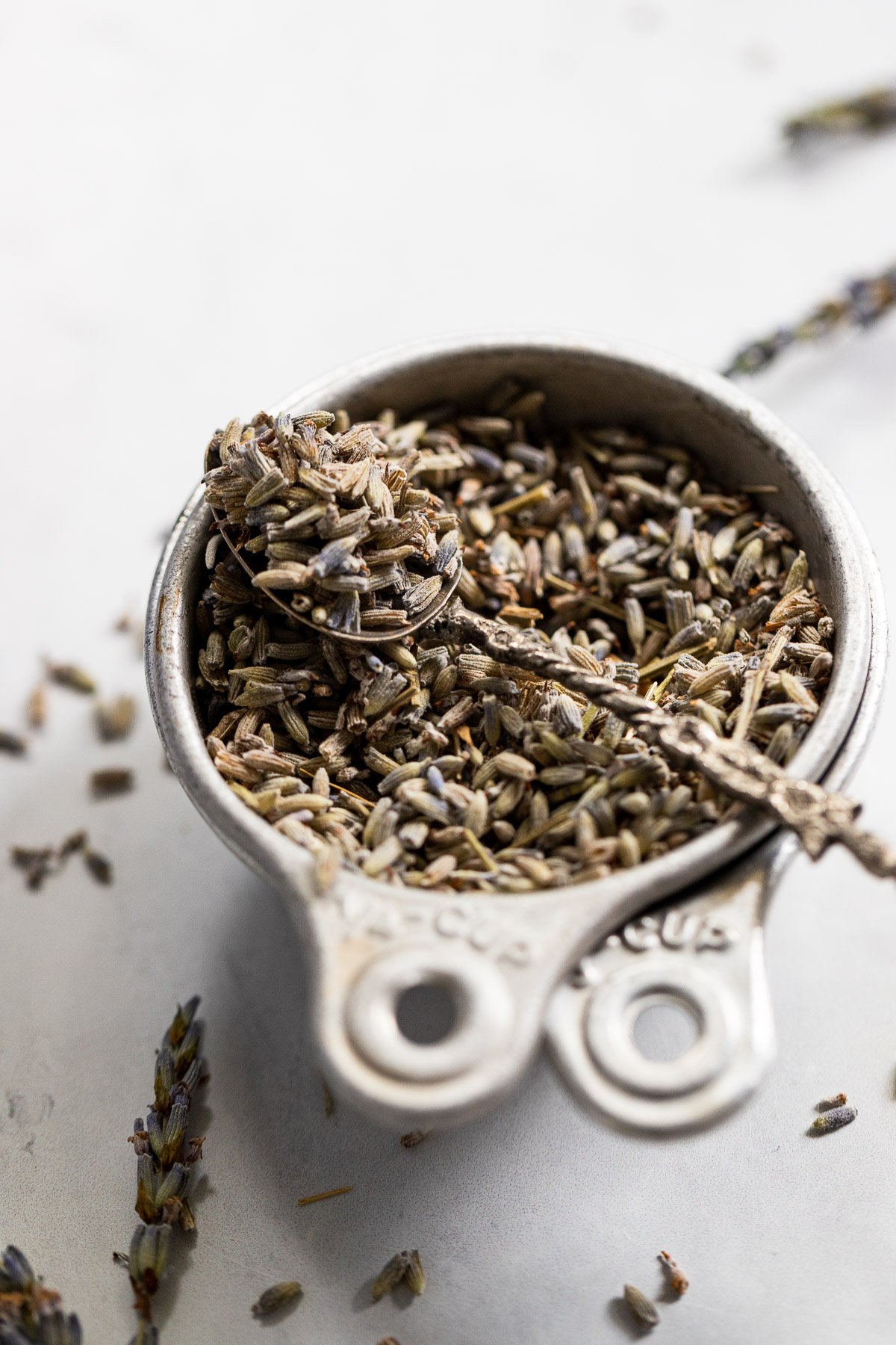 Bowl of dried lavender with a spoon.