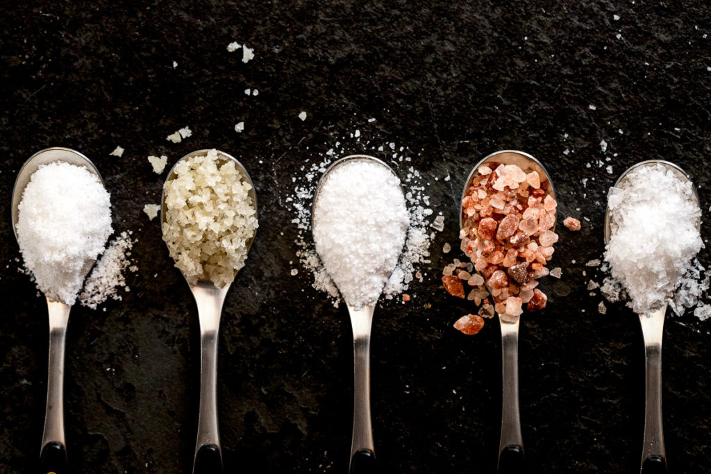 Five spoons with salt types.