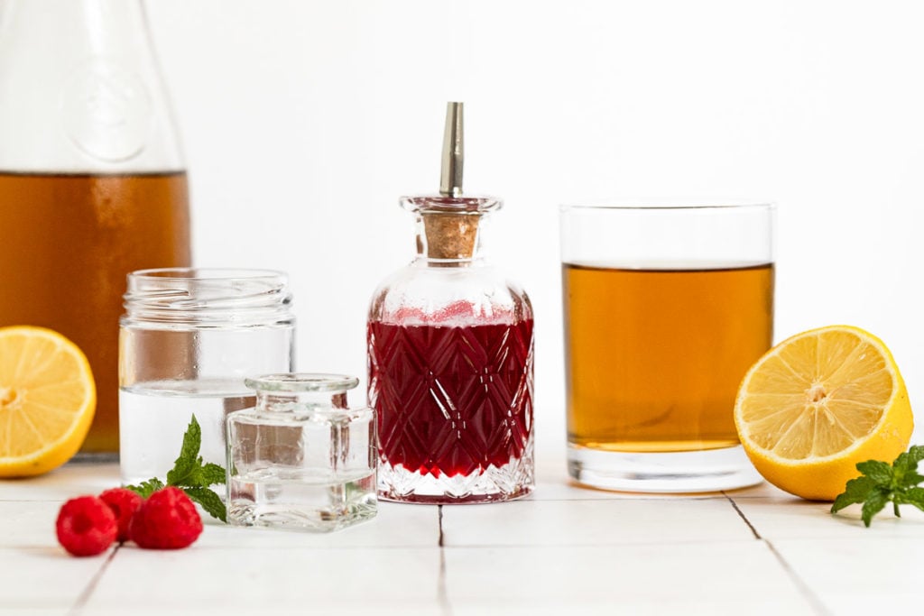Bottles of ingredients for raspberry long island iced tea.