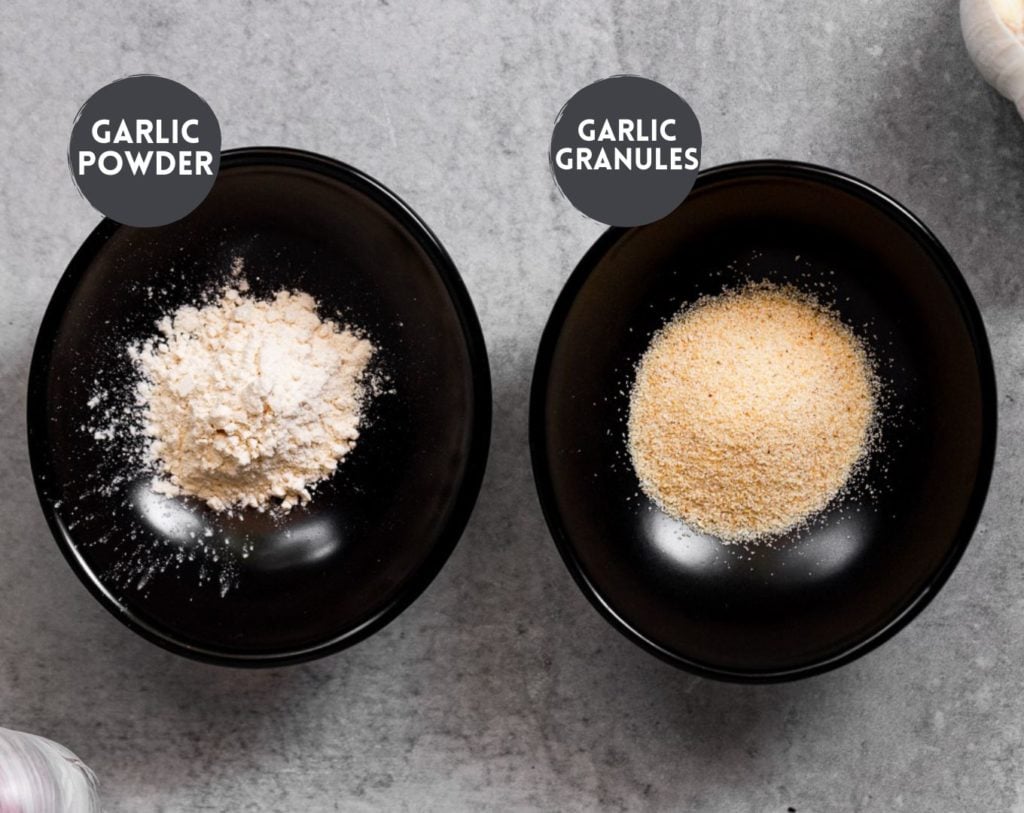 Garlic powder and granules in small black bowl.