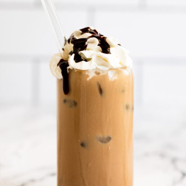 Iced mocha latte with whipped cream and chocolate syrup.