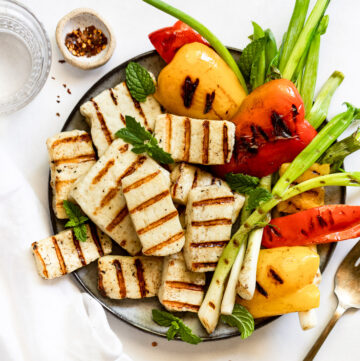 Plate of grilled halloumi and vegetables.