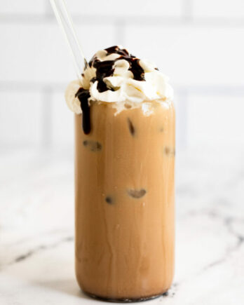 Iced mocha latte with whipped cream and chocolate syrup.