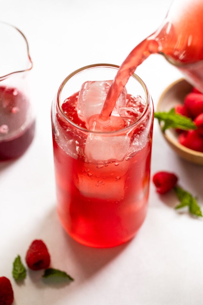 raspberry tea pouring into glass